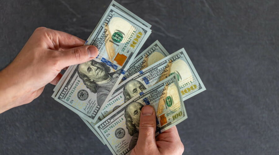 Hand holding money. international currency. exchange world money.